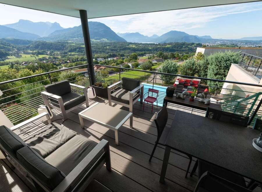 Luxury balcony with mountain views and a private pool.