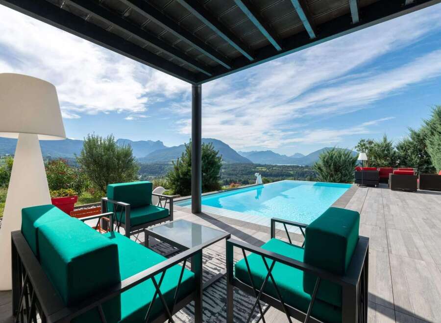 Luxury villa with infinity pool boasting breathtaking mountain views.