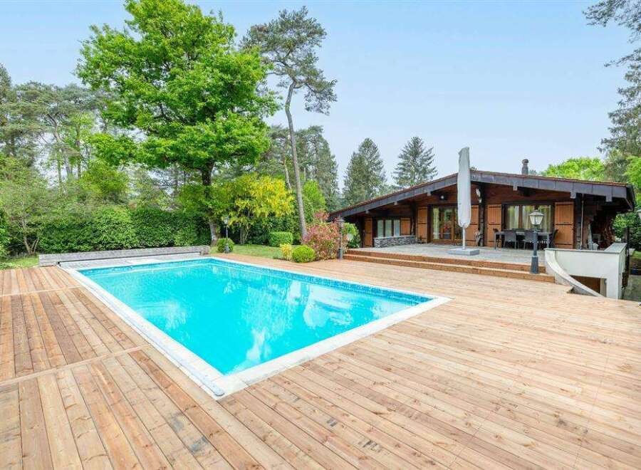 Luxury log cabin with private pool and expansive wooden deck.