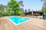 Luxury log cabin with private pool and expansive wooden deck.