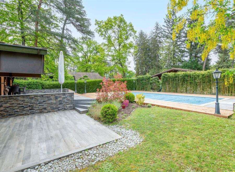 This stunning property boasts a beautiful outdoor space, complete with a large swimming pool and a spacious deck perfect for entertaining.