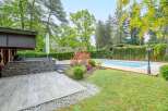 This stunning property boasts a beautiful outdoor space, complete with a large swimming pool and a spacious deck perfect for entertaining.