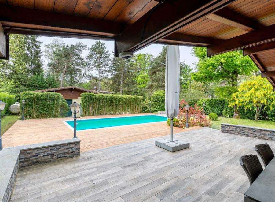 Luxury villa with a private pool and expansive wooden deck, perfect for outdoor entertaining.