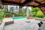 Luxury villa with a private pool and expansive wooden deck, perfect for outdoor entertaining.