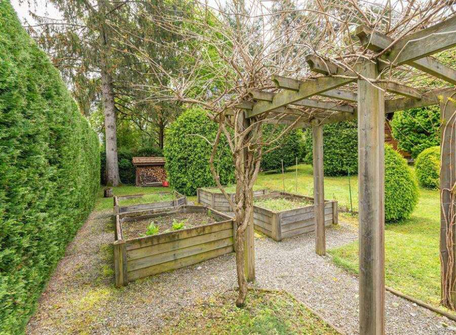 This charming property boasts a serene garden with raised wooden planters, perfect for cultivating your favorite herbs and vegetables.