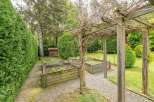 This charming property boasts a serene garden with raised wooden planters, perfect for cultivating your favorite herbs and vegetables.