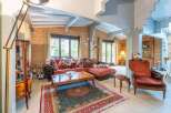 This stunning chalet boasts a spacious living area with large windows offering abundant natural light and views of the surrounding landscape.