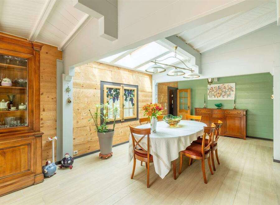 This stunning property boasts a bright and airy dining area with a vaulted ceiling and skylights, creating a naturally lit space.