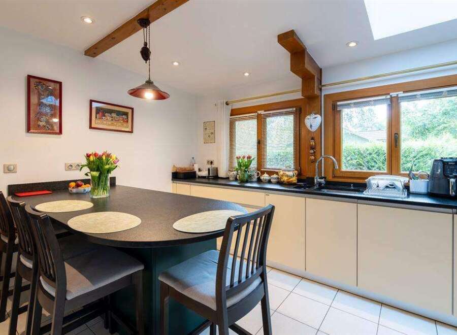 This stunning kitchen boasts a spacious island with seating, perfect for casual dining and entertaining.