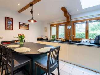 This stunning kitchen boasts a spacious island with seating, perfect for casual dining and entertaining.