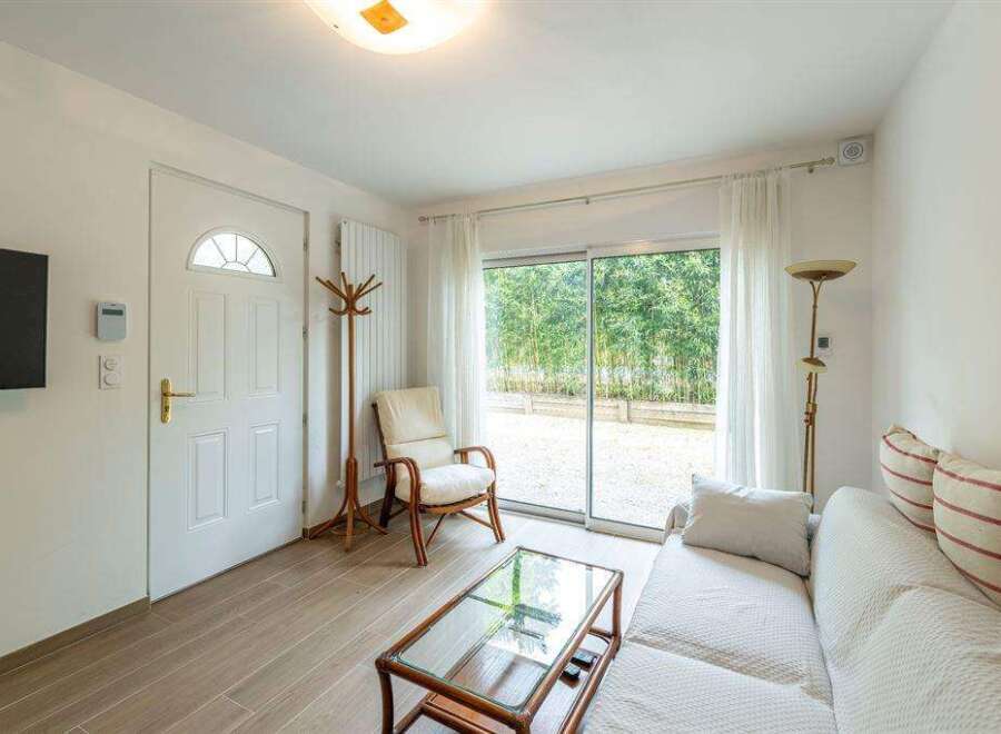 Bright and airy living space with sliding glass doors leading to a private patio.