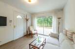 Bright and airy living space with sliding glass doors leading to a private patio.