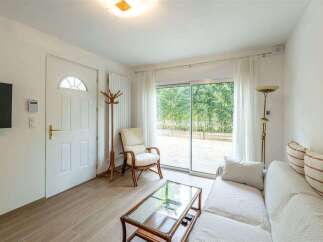 Bright and airy living space with sliding glass doors leading to a private patio.