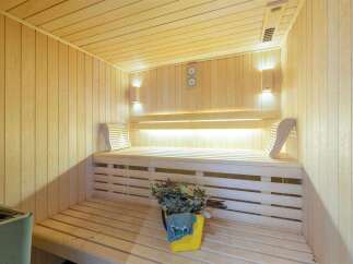 Relax and rejuvenate in this exquisite sauna, featuring calming LED lighting and premium wood paneling.