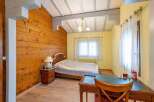 Charming bedroom with wood-paneled walls and a cozy atmosphere.