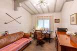 Charming study with wooden floors and beamed ceiling.