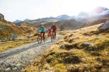 Family of four enjoys an e-bike adventure through stunning alpine scenery.