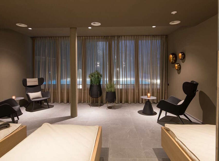 Relax and unwind in our luxurious spa, featuring comfortable lounge chairs, warm lighting, and a tranquil atmosphere.