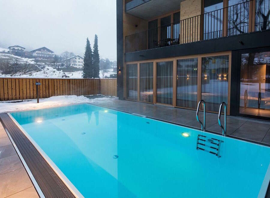 Luxury hotel with outdoor heated pool, perfect for a relaxing winter getaway.