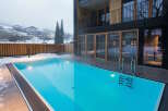 Luxury hotel with outdoor heated pool, perfect for a relaxing winter getaway.