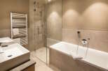 This luxurious bathroom boasts a spacious bathtub and a separate walk-in shower, perfect for relaxation and rejuvenation.