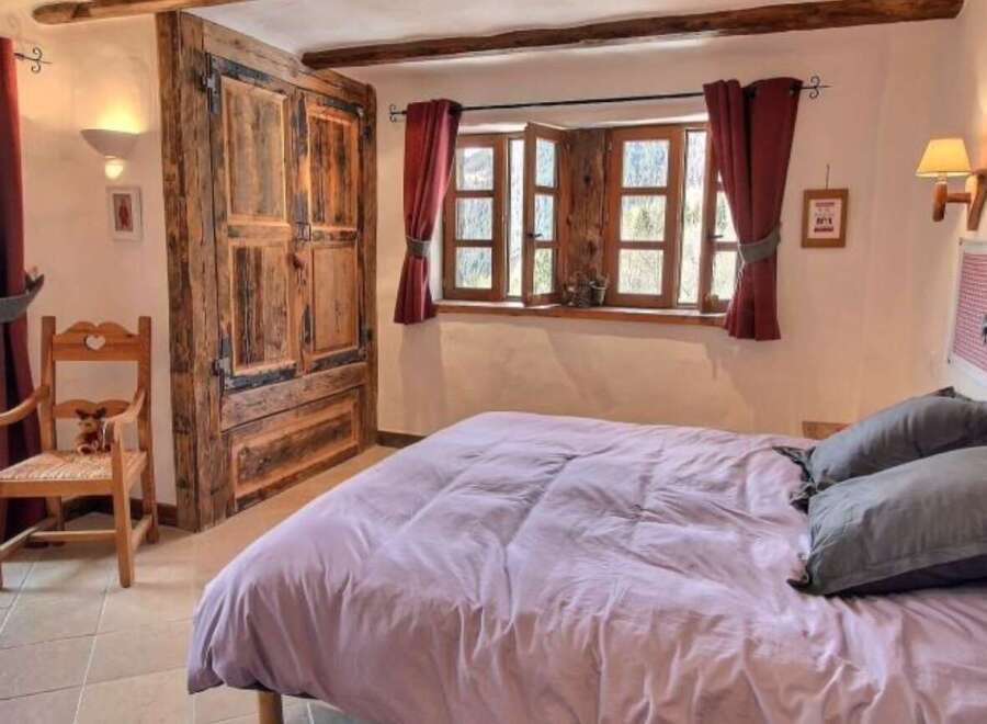 Cozy bedroom with mountain views and rustic charm.