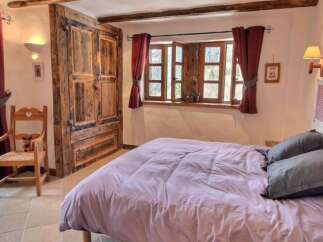 Cozy bedroom with mountain views and rustic charm.