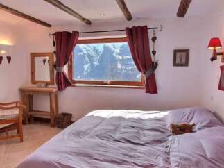 Cozy chalet bedroom with stunning mountain views.
