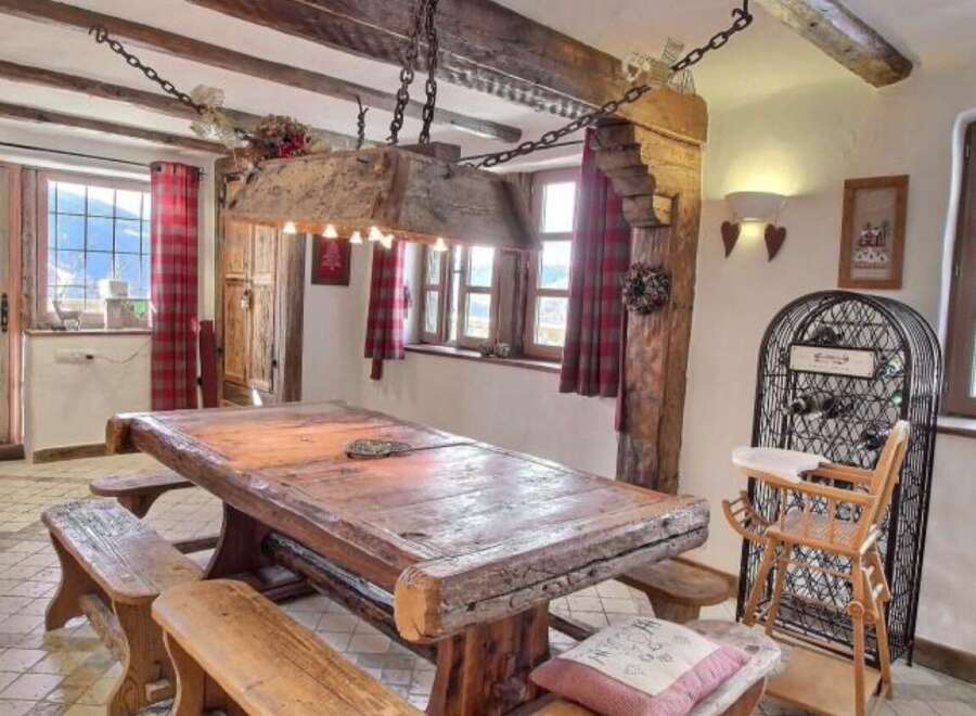 Rustic mountain chalet with charming wooden dining table and benches.