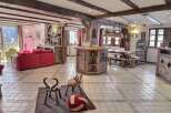 This stunning chalet boasts a spacious open-plan living area with exposed wooden beams, creating a warm and inviting atmosphere.