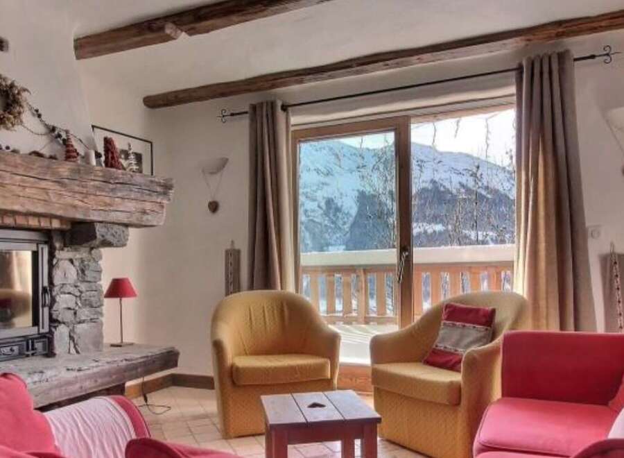 Cozy chalet with stunning mountain views and a rustic fireplace.