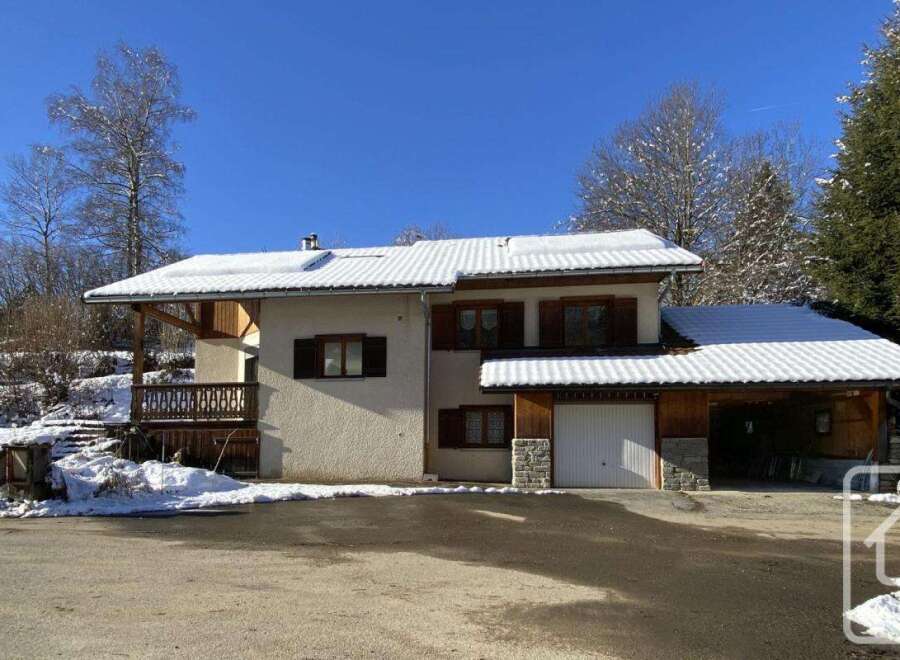 This charming chalet-style home boasts a spacious garage, perfect for storing skis and outdoor gear.