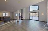 This stunning chalet boasts an open-plan living area with a modern kitchen and large windows offering breathtaking views.