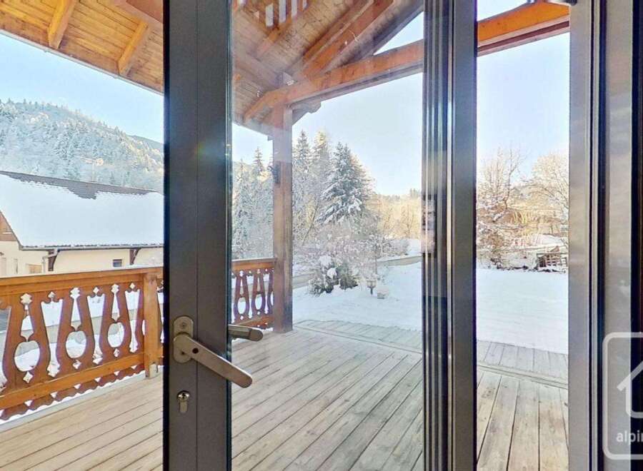 This stunning chalet boasts a spacious balcony with breathtaking mountain views, perfect for enjoying the crisp alpine air.