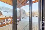 This stunning chalet boasts a spacious balcony with breathtaking mountain views, perfect for enjoying the crisp alpine air.