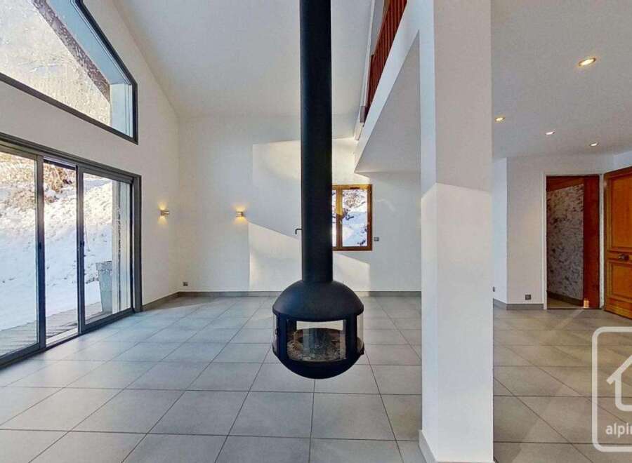 This stunning chalet boasts a spacious open-plan living area with floor-to-ceiling windows offering breathtaking views and ample natural light.