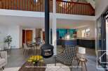 Stunning open-plan living space with a modern kitchen and a cozy fireplace, perfect for entertaining.