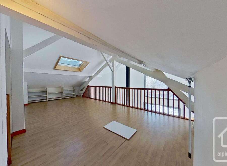 This spacious attic room boasts a light and airy feel, thanks to its large skylight and ample natural light.