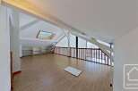 This spacious attic room boasts a light and airy feel, thanks to its large skylight and ample natural light.