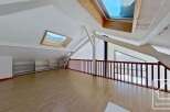 This attic conversion boasts a spacious open-plan layout with ample natural light from multiple skylights.