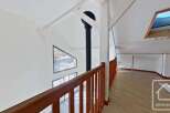 This stunning property boasts a spacious open-plan living area with large windows offering breathtaking views.