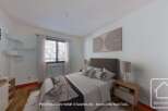 Cozy bedroom with a modern design, featuring a comfortable bed, stylish nightstand, and built-in shelving.