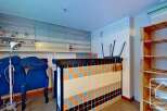 This charming property boasts a unique interior with built-in shelving, a retro-tiled counter, and ample storage solutions.