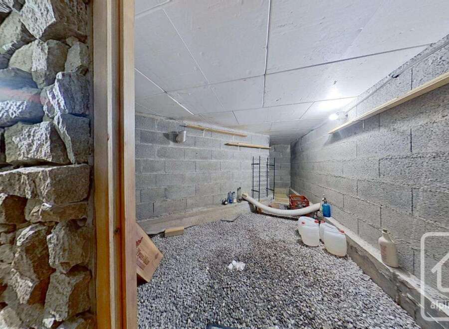 Discover this spacious cellar, perfect for storage or wine-making, featuring a gravel floor and sturdy block walls.