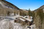 This stunning log cabin nestled in the mountains boasts breathtaking views and luxurious amenities.