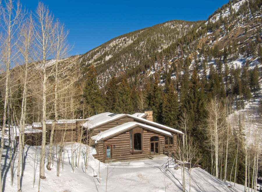 This stunning log cabin nestled in the Colorado mountains offers breathtaking views and luxurious amenities.
