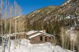 This stunning log cabin nestled in the Colorado mountains offers breathtaking views and luxurious amenities.