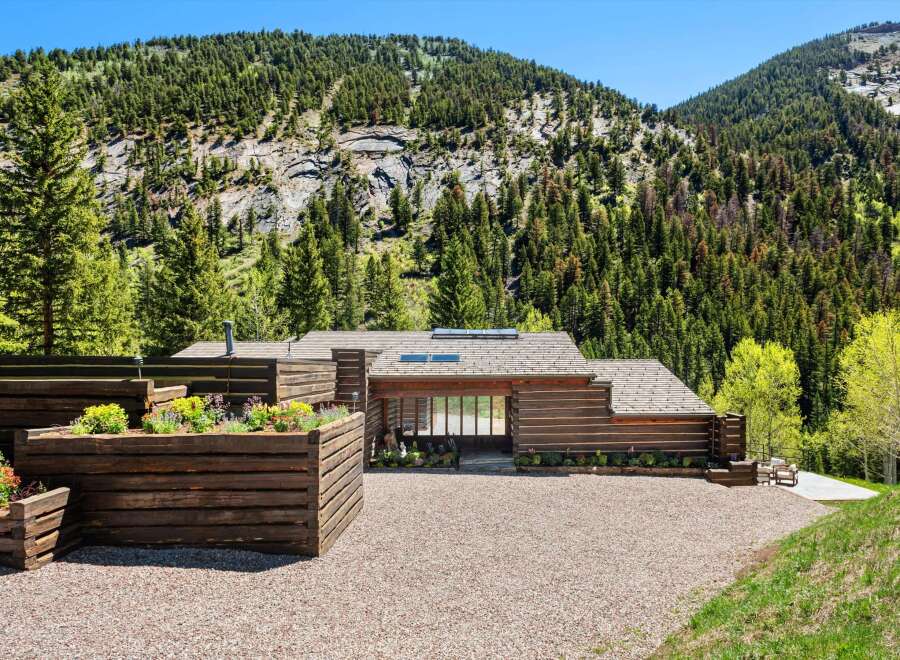This stunning log home boasts a picturesque setting nestled in the mountains, offering breathtaking views.