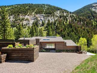 This stunning log home boasts a picturesque setting nestled in the mountains, offering breathtaking views.