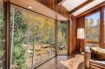 This stunning property boasts expansive windows showcasing breathtaking views of the surrounding aspen trees and mountain landscape.